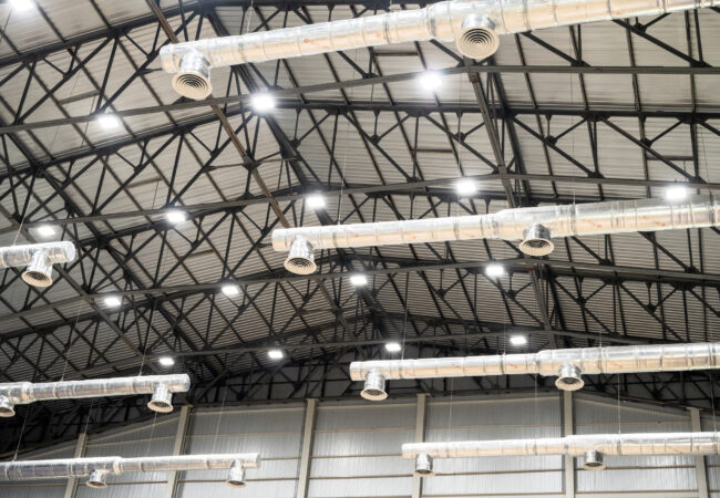 Bare ceiling with air duct, CCTV, air conditioner pipe and fire sprinkler system on white ceiling wall. Air flow and ventilation system. Ceiling lamp light with opened light. Interior architecture. Bare ceiling with air duct, CCTV, air conditioner pipe and fire sprinkler system on white ceiling wall. Air flow and ventilation system. Ceiling lamp light with opened light. Interior architecture.