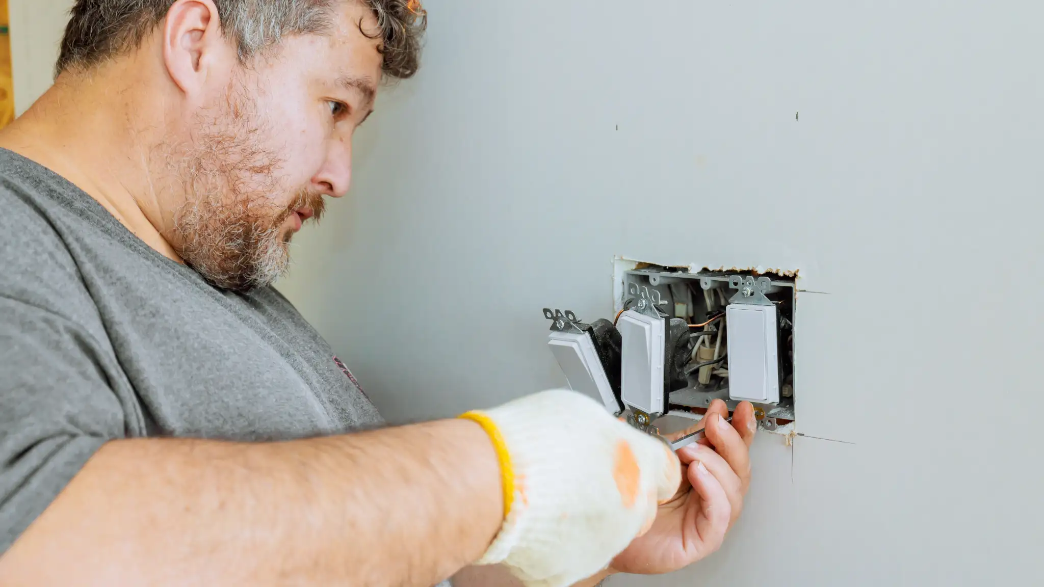 Man Installing Smart Home Wiring According to Auckland Requirements